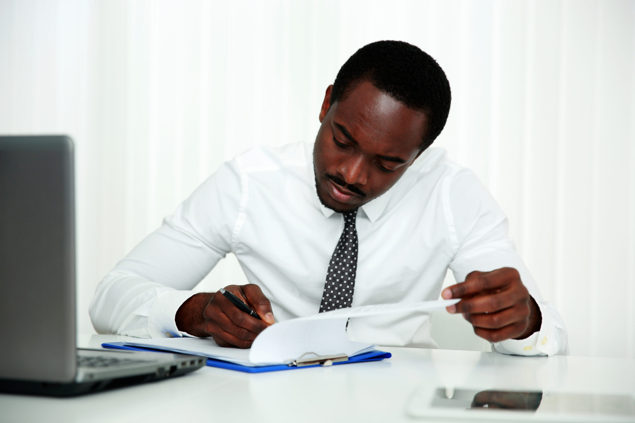 Rely on You: Reclaiming Independence in a Connected World 3 african man signing document in office scaled