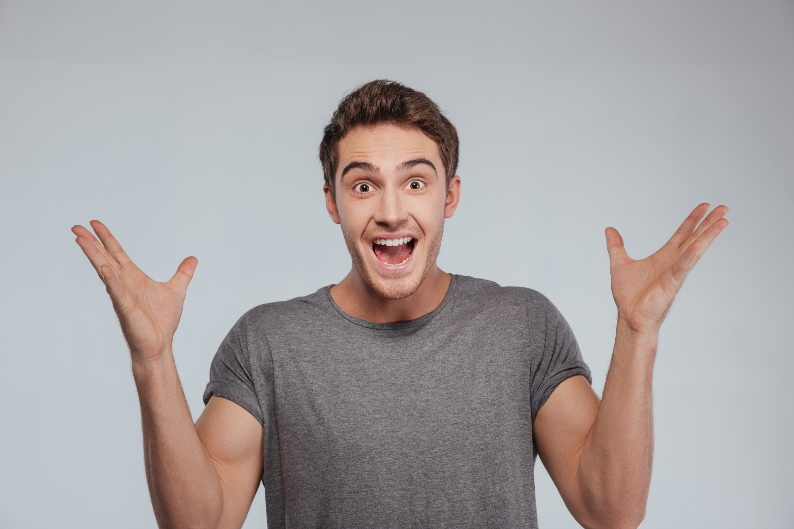 From Dependent to Unstoppable: A Roadmap to Self-Reliance 3 graphicstock portrait of an excited casual man standing with raised hands and looking at camera isolated on a white background BIVCFD7d3e scaled